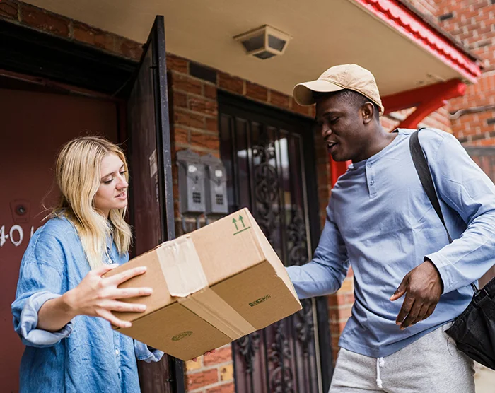 Courier man delivering package to woman