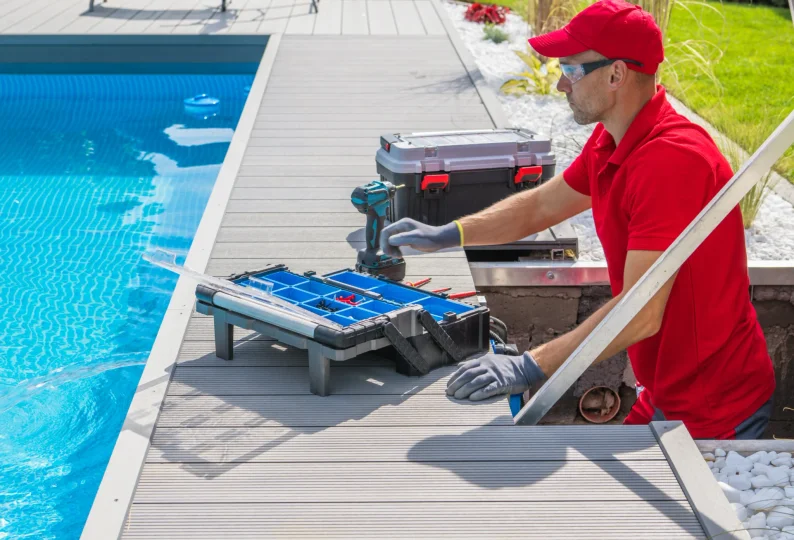 Pool service technician servicing a pool